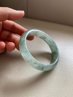 "🌈 Jade Bangle 56.0mm (2.20\"), Round Shape, Green & Light Green 🌷 Untreated Natural Jadeite/ Grade A Jade 🌷 Certified : Yes 🌷 Jade from Myanmar/ Burma 🌷 Shape : Round 🌷 Inner diameter : 56.0mm / 2.20\" 🌷 Width & Thickness : 14.1 x 6.5mm 🌷 Color : Green & Light Green 🌷 Free standard shipping from Hong Kong with tracking included 🌷 Take approximately 7-21 days to arrive worldwide ❤️ In Chinese Culture: Young people wear jade pendant will have a prosperous life, attracts good Round Jade Crystal Bracelet With Gemstone, Jade Gemstone Crystal Bracelet, Spiritual Round Bangle With Natural Stones, Jade Gemstone Bangle Bracelet, Handmade Elegant Jade Bangle, Carved Jade Bangle Bracelet, Jade Bracelet Bangles Chinese, Hand-strung Green Jade Bracelets, Hand-strung Green Jade Jewelry