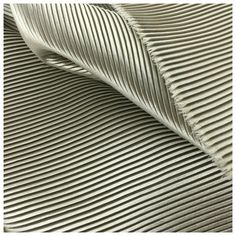 a close up view of the texture of a fabric with wavy lines in white and grey