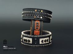 two leather bracelets are stacked on top of each other, one with an arrow in the center