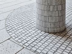 a metal pole sitting on top of a sidewalk