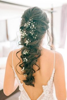 the back of a woman's head with flowers in her hair and an instagram