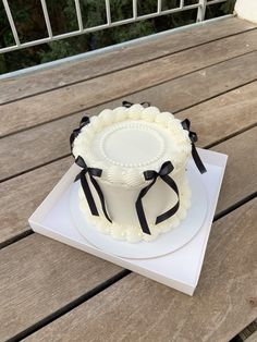 a white cake sitting on top of a wooden table