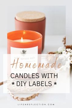 an orange candle sitting on top of a table next to some white flowers and candles