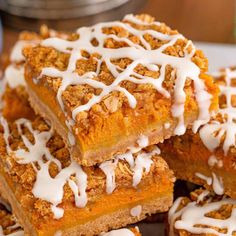 several pieces of dessert sitting on top of a plate with icing drizzled