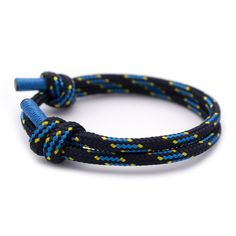 a blue and yellow braided bracelet with two black cords on top of each other