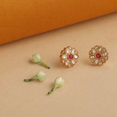 Description This pair of gold-plated silver stud earrings are designed to portray a flower bud with a delightful pink semi-precious stone. Delicate and pretty, these stud earrings are ideal companions for day-long endeavors with friends or colleagues. This product ships in 3 weeks. Product Information Metal: 925 Silver with 1.0 microns Gold Plating Length: 1.5 cm Stones: Semi-precious stones Findings: Push back closure Gemstone Earrings In Flower Shape For Gifts, Wedding Earrings With Gemstone In Flower Shape, Gemstone Flower Earrings, Flower Shaped Gemstone Earrings For Wedding, Flower Shaped Gemstone Earrings For Gifts, Gold Gemstone Flower Earrings For Wedding, Traditional Rose Gold Earrings For Gift, Traditional Pink Flower Earrings, Flower-shaped Gemstone Earrings For Weddings