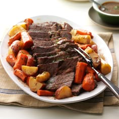 a white plate topped with meat and veggies