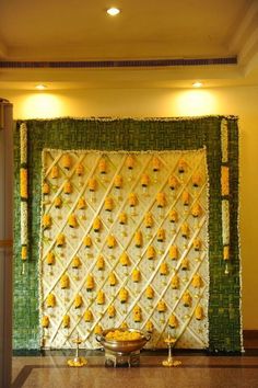 the wall is decorated with yellow and green decorations on it's sides, along with candles