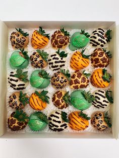 a box filled with lots of different types of decorated cookies on top of each other