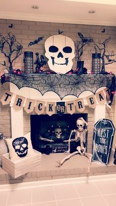 a fireplace decorated for halloween with skeleton decorations