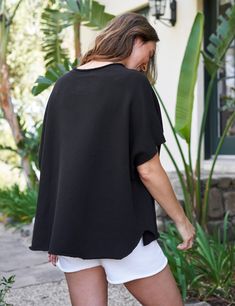 The Capelet Series is now a family of four, but it all started with the forever-perfect Original Capelet. Loose on the body, and easy for layering, the Capelet is that daily uniform piece you automatically reach for. It pairs beautifully with everything and looks pulled-together without trying too hard. Relaxed Black Top For Everyday, Relaxed Black Tops For Everyday, Versatile Oversized Black Tops, Effortless Black Relaxed Fit Tops, Black Drop Shoulder Tops For Loungewear, Black Relaxed Tops For Spring, Relaxed Black Tops For Spring, Black Batwing Sleeve Tops For Loungewear, Black Oversized Top For Day Out