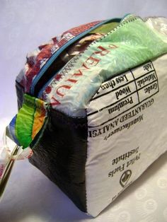 a bag filled with lots of different types of items on top of a white table