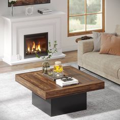 a living room with a couch, coffee table and fire place in front of the fireplace