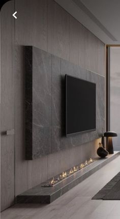 a large flat screen tv mounted to the side of a wall in a living room