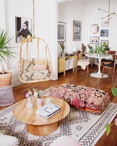 a living room filled with furniture and plants