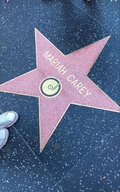 a person standing next to a star on the hollywood walk of fame