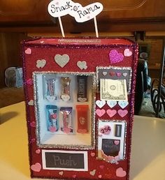 a small red refrigerator sitting on top of a table next to a sign that says snack drama