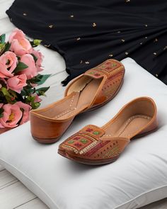 Introducing our "Artsy Tan" Punjabi jutti, a masterpiece meticulously crafted by skilled artisans from pure leather. This stunning footwear celebrates the timeless charm of tradition and craftsmanship, with its elegant tan color adorned with vibrant multi-color jari work. Each intricate detail tells a story of artistry and heritage, creating a mesmerizing tapestry of hues that captures the essence of Punjab's rich cultural heritage. What truly sets the "Artsy Tan" jutti apart is its unique upper Indian Footwear Women, Indian Shoes, Punjabi Jutti, Shoe Gifts, Traditional Indian, Cultural Heritage, Handcrafted Leather, Tan Color, Women's Shoes Sandals