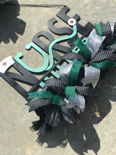 a metal sign that says welcome to canada with green and silver bows on it's side