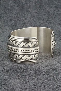 This stunning sterling silver bracelet was made by Navajo silversmith Raymond Delgarito. The back is signed RD and stamped sterling.Size: 5 1/4" (will fit up to a 6 1/4" wrist)Gap: 1"Width: 1 1/4"Free shipping on all orders! We ship with USPS and always include tracking. All orders ship within a day of payment.Returns are accepted up to 30 days after you receive your order. Just send us a message. Our shop offers cash back or store credit. The item must be returned in new condition. Bohemian Wide Band Engraved Jewelry, Southwestern Sterling Silver Bracelet Stamped 925 As Gift, Engraved Sterling Silver Bohemian Bracelet, Bohemian Sterling Silver Engraved Bracelet, Collectible Sterling Silver Bracelets With Oxidized Finish, Handmade Sterling Silver Cuff Bracelet Collectible, Unique Antique Silver Sterling Silver Bracelet, Southwestern Silver Bangle Jewelry, Unique Adjustable Etched Sterling Silver Bracelet