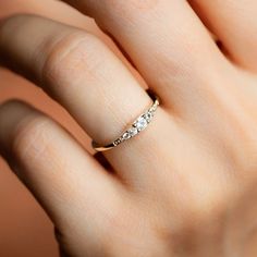 a woman's hand with a diamond ring on it