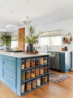 a kitchen filled with lots of different types of spices and seasonings on top of blue cabinets