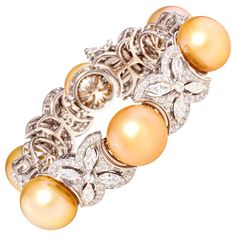 The golden pearl and diamond bracelet features six large untreated golden pearls from the waters of Indonesia. The pearls display a beautiful nacre and their natural color and high luster have not been enhanced in any way. The diameter ranges between 16-17mm. The interspersed floral motifs are set with 6.20 of marquise cut diamonds and a total of 3.60 carats of round diamonds of top quality (F/G-VVS). The bracelet is one-of-a-kind. It was entirely handmade in Italy with exquisite craftsmanship a Diamond Cuff Bracelet, Pearl Cuff Bracelet, Cultured Pearl Bracelet, Diamond Bracelet Design, Golden Pearl, Jewellery Design Sketches, Nouveau Jewelry, Pearl Cuff, Pearl Gifts