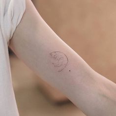 a woman's arm with a small tattoo on the left side of her arm