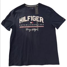 A Blue Tommy Hilfiger Nwt T-Shirt Tommy Hilfiger Crew Neck Shirt For Summer, Tommy Hilfiger Summer Crew Neck Shirt, Tommy Hilfiger Crew Neck Shirt With Letter Print, Tommy Hilfiger Graphic Tee For Summer, Tommy Hilfiger Graphic Tee With Letter Print, Tommy Hilfiger Short Sleeve Top With Letter Print, Tommy Hilfiger Graphic Tee With Crew Neck, Tommy Hilfiger Casual Graphic Print Tops, Tommy Hilfiger Graphic Tee With Short Sleeves