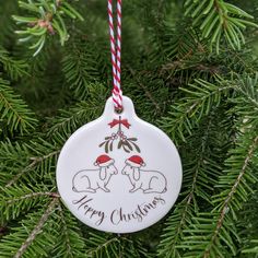 a ceramic ornament hanging from a christmas tree