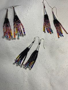 Native American Inspired Fringe Earrings with Feathers - My Community Made Multicolor Long Drop Beaded Earrings With Fringe, Multicolor Long Drop Fringe Earrings, Artisan Multicolor Beaded Tassel Earrings, Multicolor Beaded Fringe Earrings With Unique Style, Multicolor Beaded Tassel Earrings As Gift, Unique Multicolor Beaded Fringe Earrings, Long Drop Beaded Tassel Earrings For Festival, Multicolor Fringe Beaded Earrings As Gift, Adjustable Multicolor Beaded Fringe Earrings