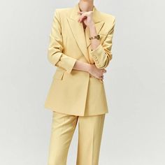 Discover Elegance and Professional Style Step into the office with confidence and style with our Elegant Yellow Pantsuit for Women. This chic and sophisticated two-piece set, featuring a long sleeve blazer and matching wide-leg pants, is the epitome of professional grace and modern fashion. Designed for the contemporary woman, this outfit seamlessly blends formal elegance with casual comfort, making it a versatile addition to your wardrobe. Exquisite Design and Quality Our pantsuit is crafted with meticulous attention to detail. The double-breasted blazer, with its sharp notched collar and full-length sleeves, pairs perfectly with the wide-leg pants, offering a slim and streamlined silhouette. The mid-waist design and flat front style ensure a flattering fit for all body types. The broadcl Chic Pantsuit With Lapel Collar For Office Wear, Tailored Spring Workwear Sets, Tailored Spring Sets For Workwear, Chic Spring Suits For Career, Spring Office Wear Pantsuit With Notch Lapel, Chic Career Pantsuit With Lapel Collar, Formal Long Sleeve Pantsuit For Fall, Chic Lapel Collar Pantsuit For Workwear, Chic Spring Career Suits