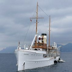 a large white boat floating on top of the ocean