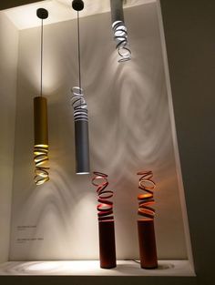 three different colored lights hanging from the ceiling