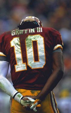 a close up of a football player wearing a uniform