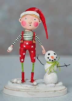 a small figurine with a snowman next to it