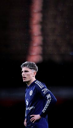 a man standing on top of a soccer field