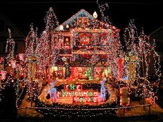 a house covered in christmas lights with the words festivus over it