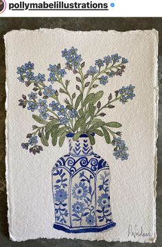 a blue and white vase with flowers in it