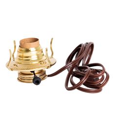 a brass plated water heater with two brown hoses