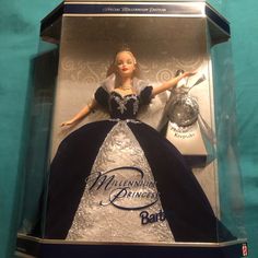 a barbie doll in a box with a blue dress