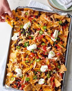 a pan filled with nachos and black beans