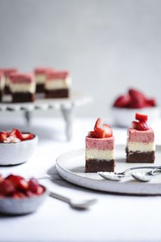 three pieces of cake with strawberries on top