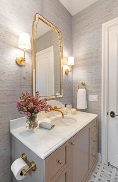 a bathroom with a sink, mirror and lights