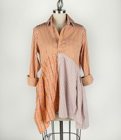 an orange and white striped shirt on a mannequin