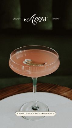 a pink cocktail sitting on top of a table