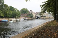 boats are parked along the side of a river