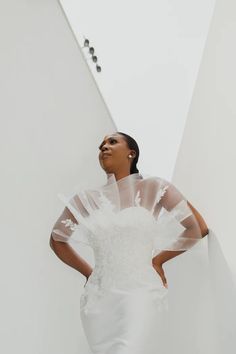 a woman in a white wedding dress and veil