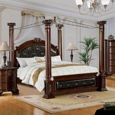 a bedroom with four post bed and chandelier in the corner, along with two lamps on either side of the bed