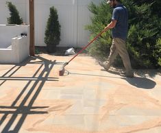 a man with a mop is cleaning the yard